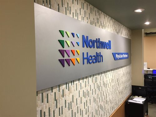 Northwell health logo Brushed aluminum panel, 1/4" thick  laser cut acrylic logo painted muliple pms colors  Installed  Incorporated Village of Island